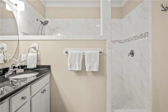 bathroom featuring vanity, tiled shower, and crown molding