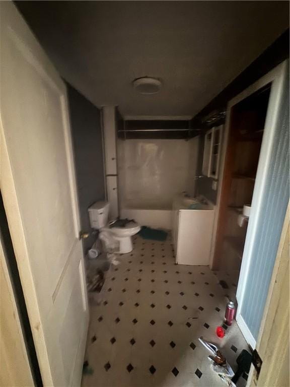 full bathroom featuring toilet, walk in shower, and tile patterned floors