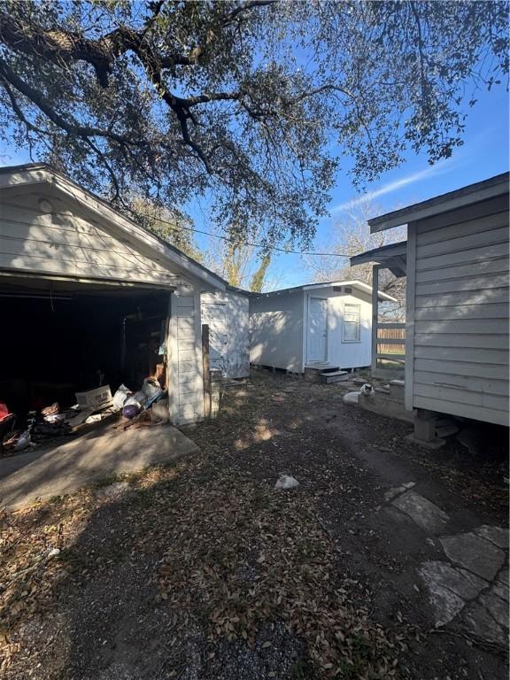 exterior space featuring a shed and an outbuilding