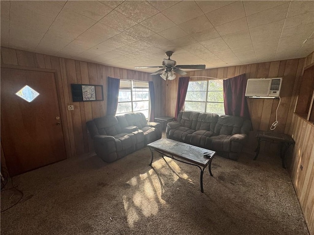 living room featuring carpet floors, a wall mounted AC, a ceiling fan, and wooden walls