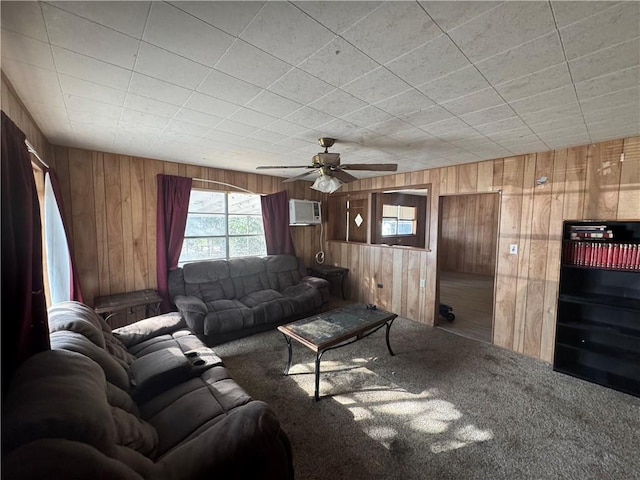 unfurnished living room with carpet floors, a wall unit AC, ceiling fan, and wooden walls