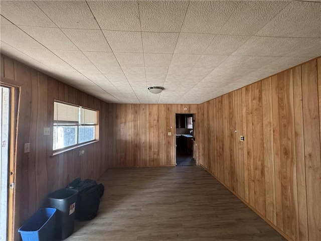 corridor featuring wood walls and wood finished floors