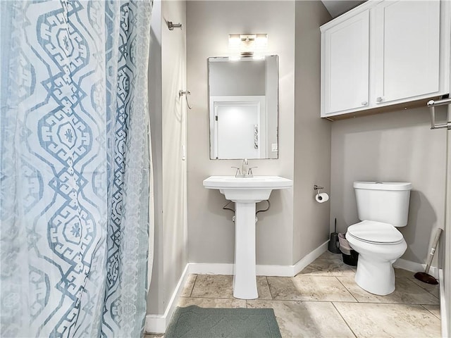 14309 Ridley Way, Corpus Christi, TX 78418 - bathroom featuring baseboards and toilet