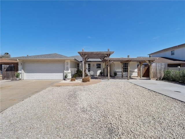 ranch-style home with fence, driveway, an attached garage, and a pergola