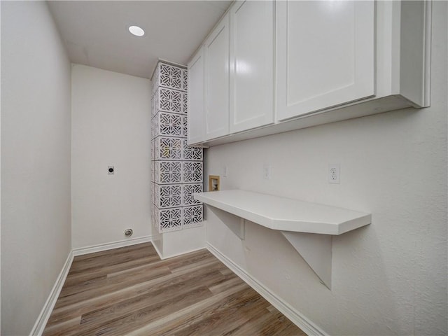 13818 Halyard Dr, Corpus Christi, TX 78418 - laundry room featuring hookup for a washing machine, cabinet space, electric dryer hookup, wood finished floors, and baseboards