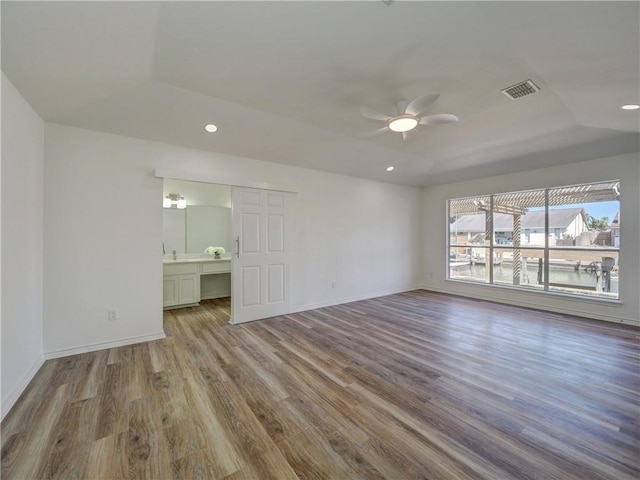 13818 Halyard Dr, Corpus Christi, TX 78418 - empty room with wood finished floors, recessed lighting, a raised ceiling, and baseboards