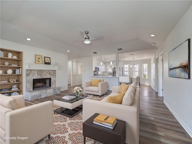 13818 Halyard Dr, Corpus Christi, TX 78418 - living room featuring built in shelves, recessed lighting, a premium fireplace, and wood finished floors