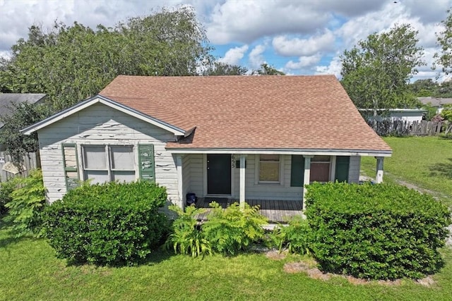 3655 Santa Fe St, Corpus Christi, TX 78411 - view of front of home with a front yard, covered porch, and roof with shingles