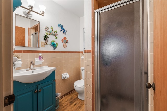 bathroom featuring tile walls, an enclosed shower, vanity, and hardwood / wood-style flooring