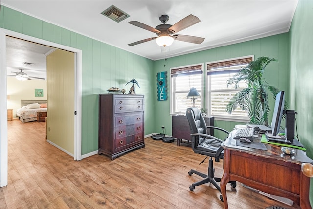 office area with light hardwood / wood-style floors, ceiling fan, and ornamental molding