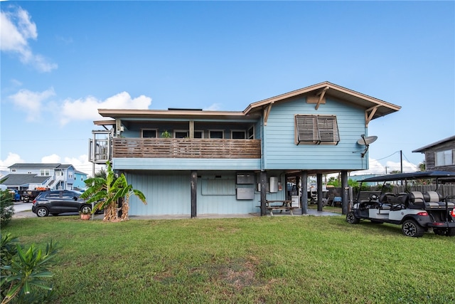 view of front of home featuring a balcony and a front yard