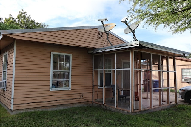 view of side of property featuring a sunroom