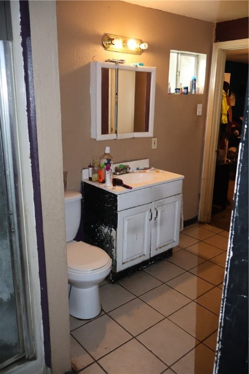 bathroom with vanity, tile patterned floors, and toilet