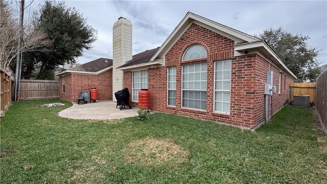 5906 Lindenwood Dr, Corpus Christi, TX 78414 - rear view of house with cooling unit, a yard, and a patio