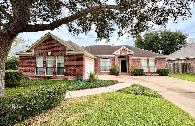 ranch-style house featuring a front lawn and a garage