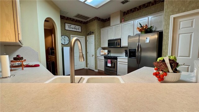 5906 Lindenwood Dr, Corpus Christi, TX 78414 - kitchen with a skylight, sink, and appliances with stainless steel finishes