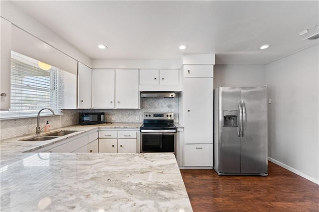 4002 Brawner Pkwy, Corpus Christi, TX 78411 - kitchen with stainless steel appliances, a sink, under cabinet range hood, white cabinetry, and light stone countertops