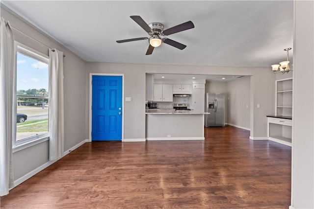 4002 Brawner Pkwy, Corpus Christi, TX 78411 - unfurnished living room featuring plenty of natural light, dark wood-type flooring, and a chandelier