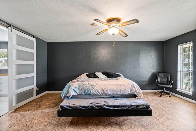 5110 Cascade Dr, Corpus Christi, TX 78413 - bedroom with a textured ceiling, ceiling fan, and a barn door