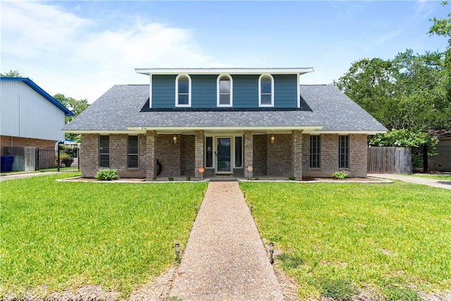 5110 Cascade Dr, Corpus Christi, TX 78413 - view of front of home with covered porch, brick siding, and roof with shingles