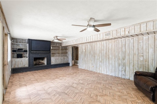 5110 Cascade Dr, Corpus Christi, TX 78413 - unfurnished living room with ceiling fan, a brick fireplace, and built in shelves