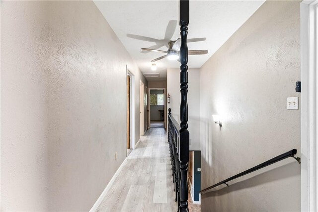 5110 Cascade Dr, Corpus Christi, TX 78413 - hall with light wood-type flooring, an upstairs landing, and a textured wall
