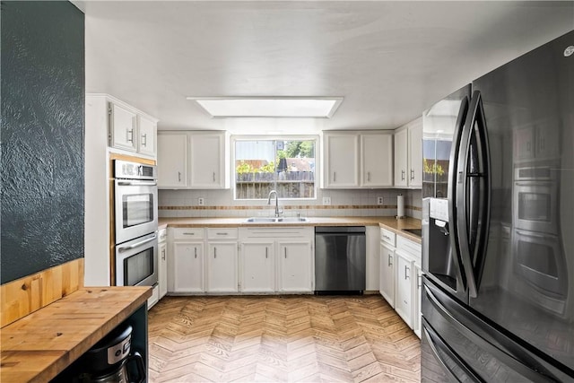5110 Cascade Dr, Corpus Christi, TX 78413 - kitchen with appliances with stainless steel finishes, decorative backsplash, plenty of natural light, and light countertops