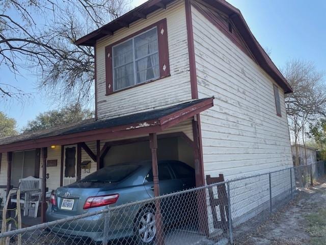 view of home's exterior featuring a porch and a carport