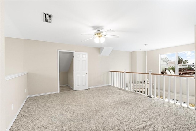 spare room featuring ceiling fan and carpet