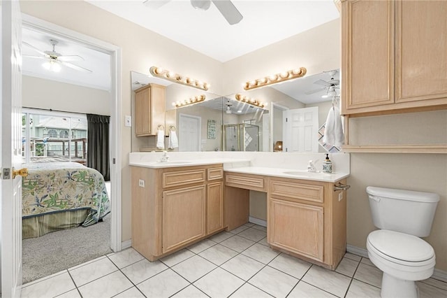 bathroom with tile patterned flooring, vanity, and toilet