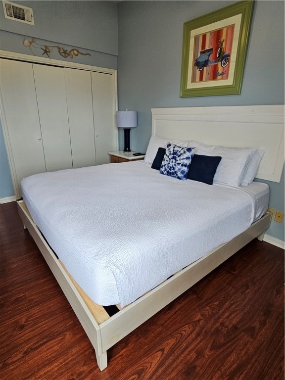 bedroom featuring dark hardwood / wood-style floors and a closet