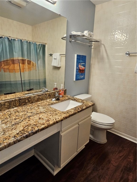 bathroom with toilet, a shower with curtain, vanity, and wood-type flooring