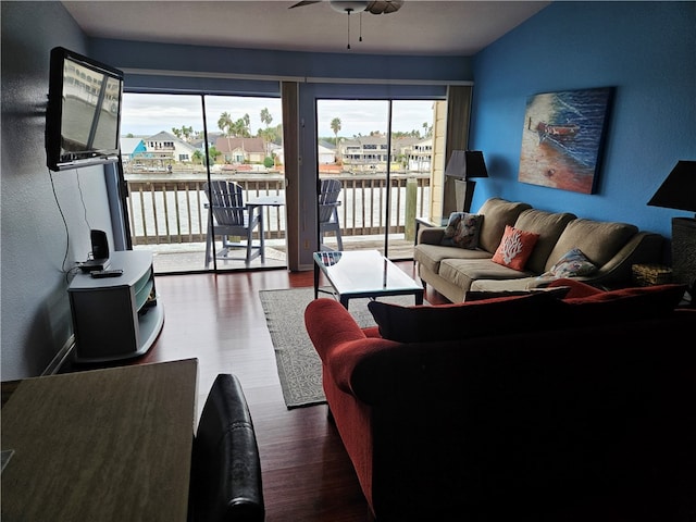 living room featuring a wealth of natural light, dark hardwood / wood-style floors, and ceiling fan