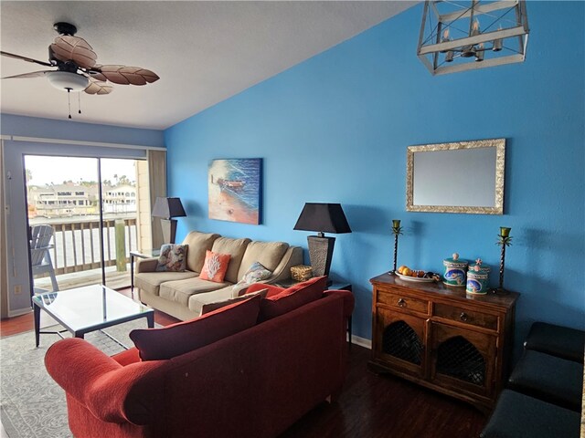 living room with lofted ceiling, hardwood / wood-style flooring, and ceiling fan