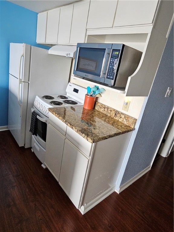 kitchen featuring extractor fan, dark hardwood / wood-style floors, backsplash, white cabinetry, and dark stone countertops