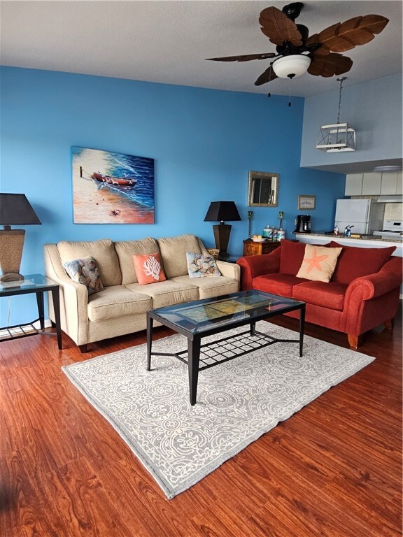 living room with hardwood / wood-style floors and ceiling fan