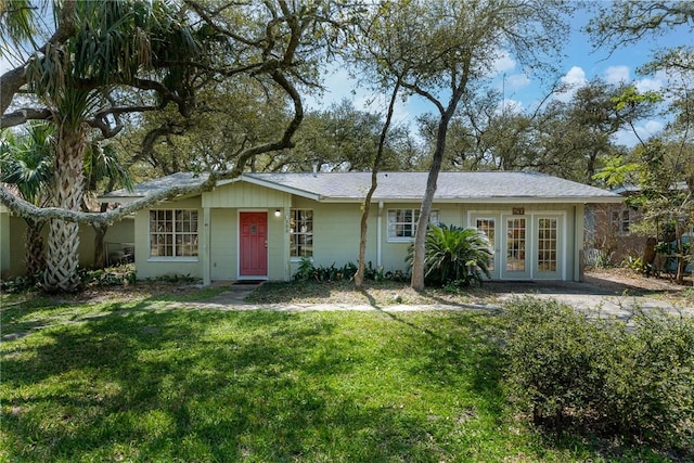 view of front of property featuring french doors and a front lawn