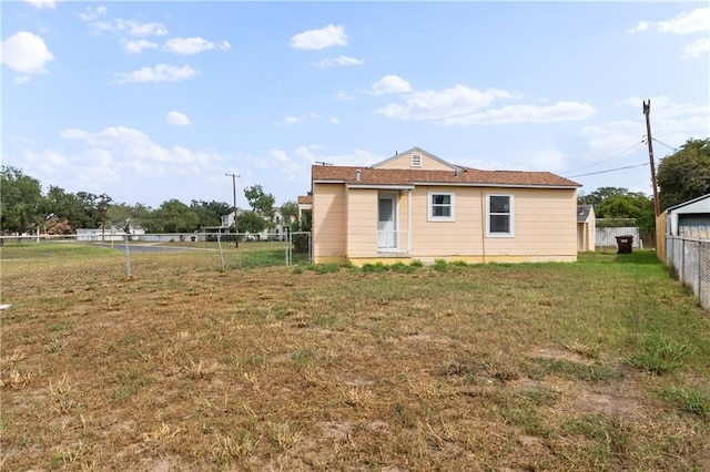 rear view of property with a lawn