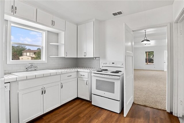 kitchen featuring tile countertops, white cabinets, sink, dark hardwood / wood-style floors, and white appliances