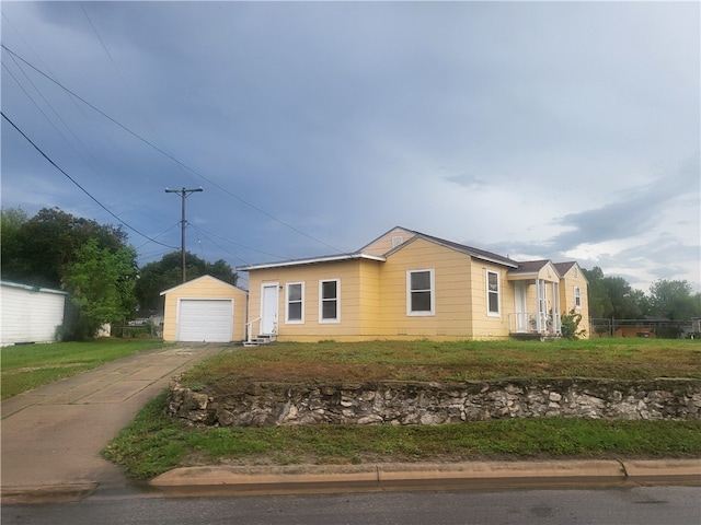 single story home with a garage and an outdoor structure