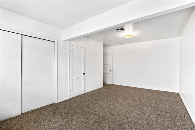 unfurnished bedroom with a closet and carpet