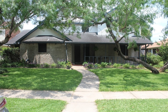 6605 Whitewing Dr, Corpus Christi, TX 78413 - view of front facade with a front yard, roof with shingles, and covered porch