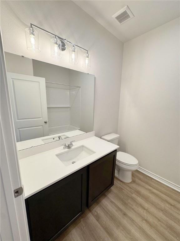 1931 Topwater, Aransas Pass, TX 78336 - full bathroom featuring wood finished floors, baseboards, vanity, and toilet