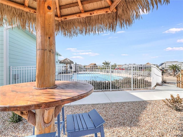 view of patio with a fenced in pool and fence