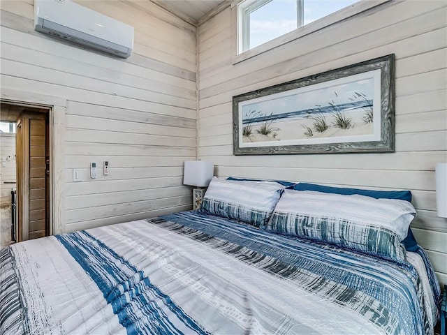 bedroom featuring wood walls and a wall mounted AC