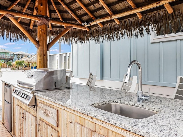 view of patio / terrace with a gazebo, exterior kitchen, grilling area, and a sink