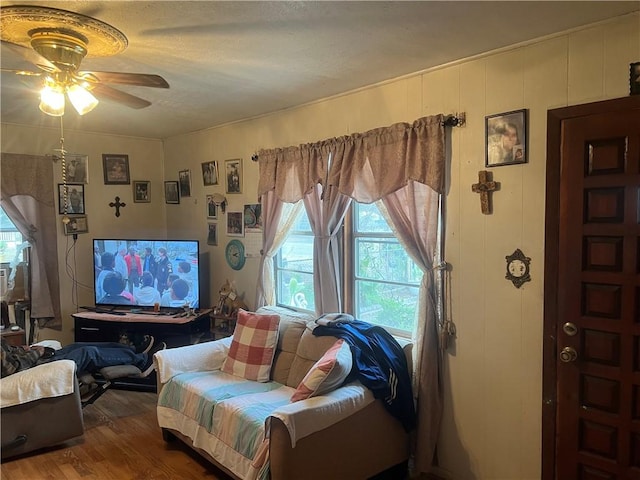 living room with hardwood / wood-style floors and ceiling fan