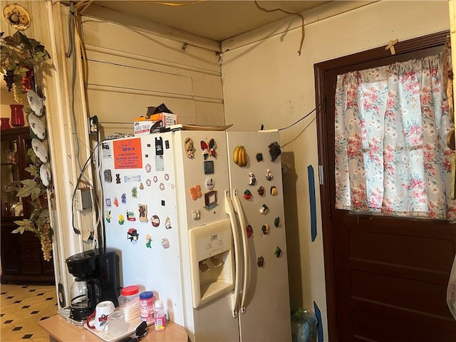 kitchen with white fridge with ice dispenser