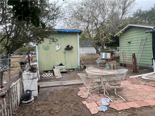 view of patio featuring a storage unit