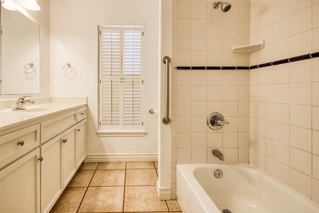 bathroom with vanity, baseboards, tile patterned flooring, and shower / washtub combination